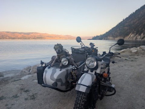Golden hour at the lakeshore, helmet still on. No hurry to clock out.