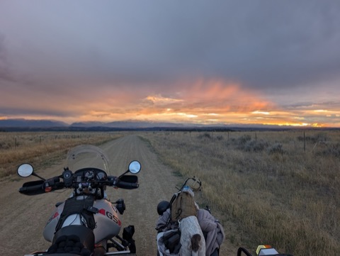 Sunset over the mountains, gravel road to ourselves.