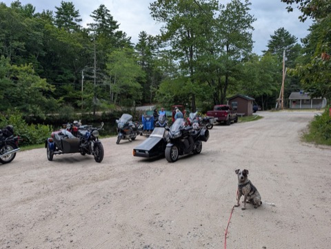 Sidecar rally ride stop in Maine. Kyro holds the parking lot while the humans talk shop.